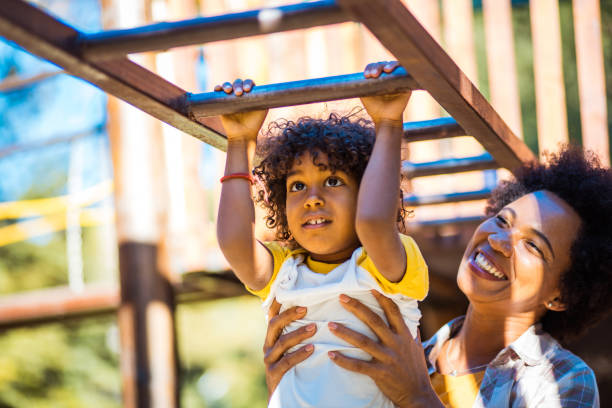 istock Mother and daughter on playground. 1312067062