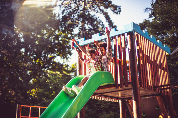 istock African American mom playing with son on toboggan. 1312067174