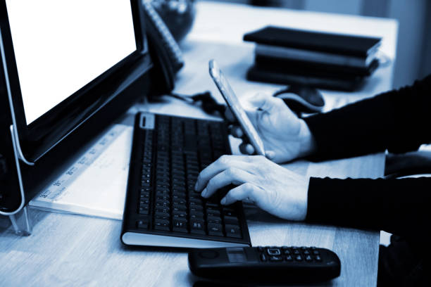 istock Businesswoman using a mobile phone and a laptop while working. 1312068049