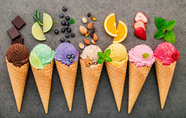 istock Flat lay ice cream cones collection on dark stone background . Blank crispy ice cream cone with copy space for sweets menu design. 1312068350