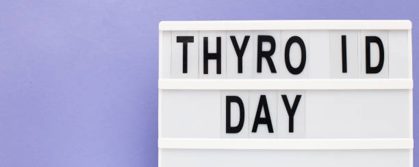 istock inscription international thyroid day on purple background. copy space. banner 1312072211