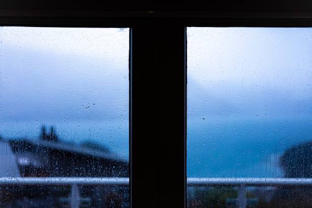 Raindrops on window glass with blur background