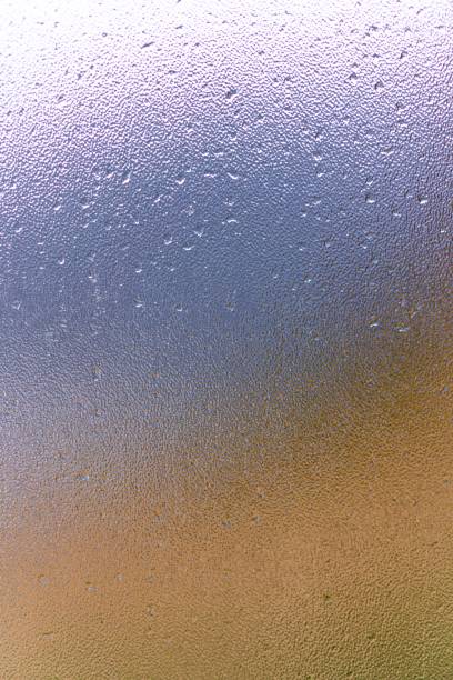 istock Raindrops on window glass with blur background 1312072293