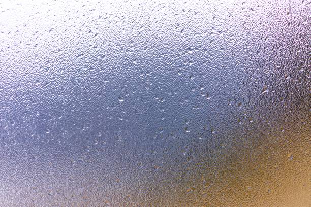 istock Raindrops on window glass with blur background 1312072382