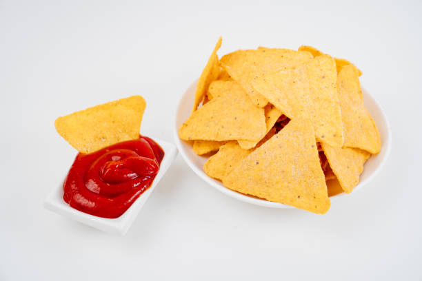 istock Nachos with tomato sauce on the white table. 1312073813