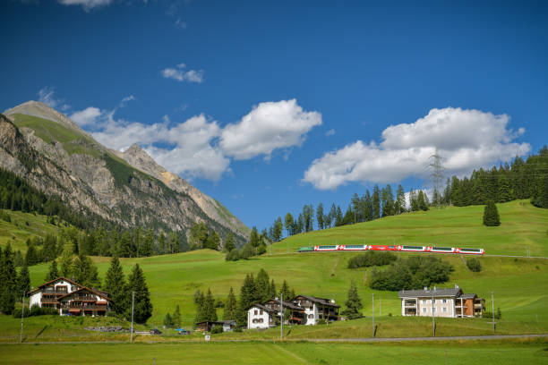 Bergun, Switzerland - August 4, 2019: Glacier express train on Albula line close to Bergun in Switzerland during sunny summer day in August 2019