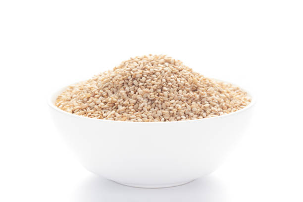 istock Close up of Organic White Sesame seeds(Sesamum indicum) or white Til with shell inside a white ceramic bowl 1312075843