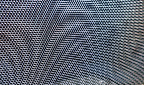 istock Abstract metallic background with round holes 1312075946