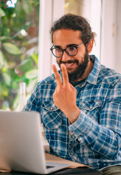 istock Young Man Having a Video Call With Sign Language on Laptop 1312076957