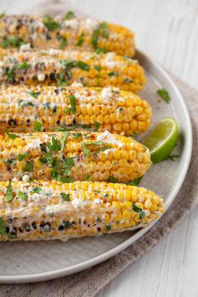 istock Homemade Elote Mexican Street Corn on a plate, side view. 1312077131