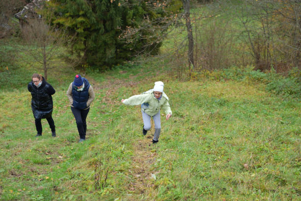 istock A young girl runs along a hiking trail with joy between parents 1312079216