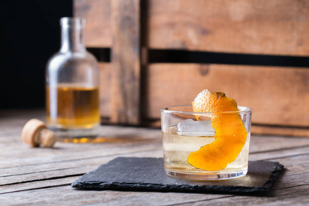 Oaxaca old fashioned cocktail with Mexican mezcal and tequila Oaxaca old fashioned cocktail with mexican mezcal or mescal, tequila and flamed orange peel tequila worm stock pictures, royalty-free photos & images