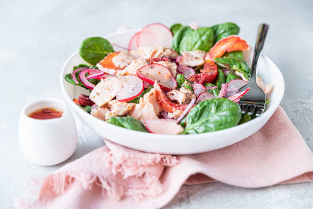 istock Fresh salad with salmon, spinach, radish and red oranges served with orange sauce, light concrete background. 1312081902