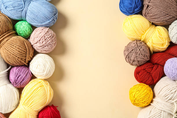 istock Colorful woolen yarns on beige background, flat lay. Space for text 1312084020
