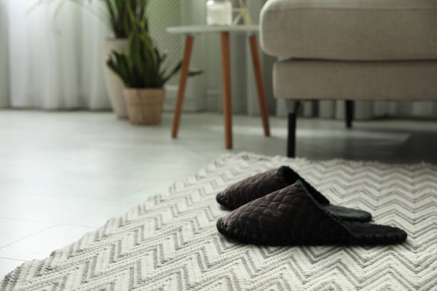 istock Soft slippers on carpet in living room 1312084253