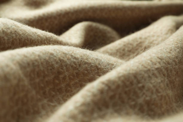istock Beige woolen fabric with geometrical pattern, closeup 1312084418