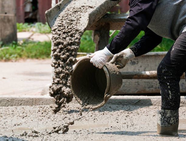 istock professional worker building house use bucket mix and fill liquid cement on floor. Making concrete street in construction site 1312085252