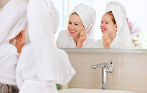 istock Mother and daughter doing face skin care 1312085910