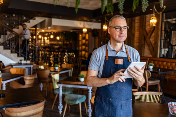 istock Male barista holding digital tablet 1312086792