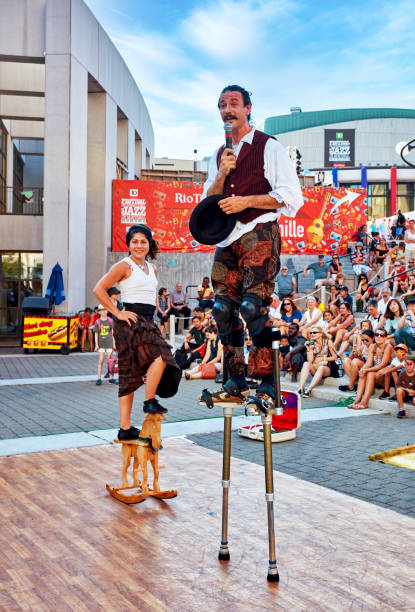 male and female acrobats perform on an outdoor stage at montreal jazz festival in quebec, canada. - traditional festival juggling women performer imagens e fotografias de stock