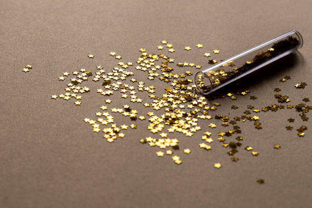 Golden sparkles stars on gold holiday background. Festive backdrop for your projects.