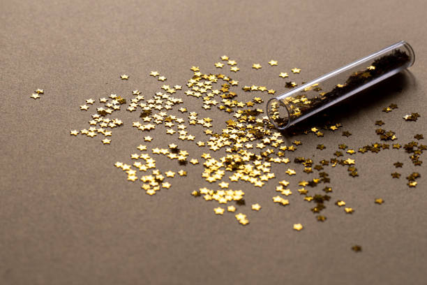 Golden sparkles stars on gold holiday background. Festive backdrop for your projects. stock photo