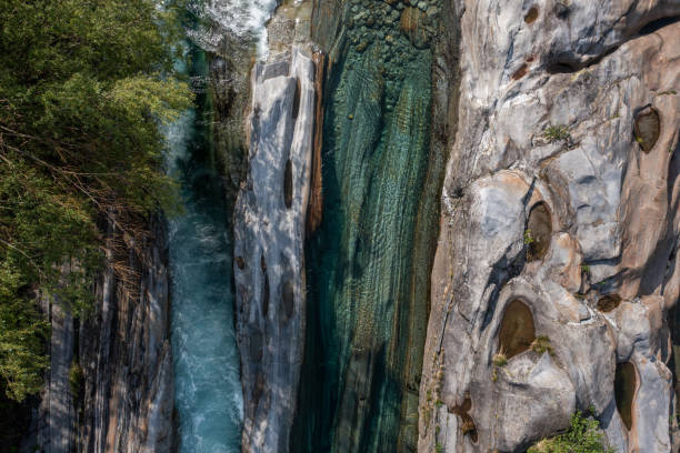 Amazing shot of the clear emerald-coloured water river and gem-like rock formation.Ticino canton, Switzerland