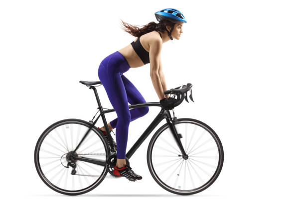 istock Fit young woman riding a bicycle with a helmet 1312095731
