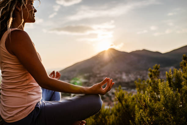 istock Young woman preforms yoga in mountains at sunset 1312096128
