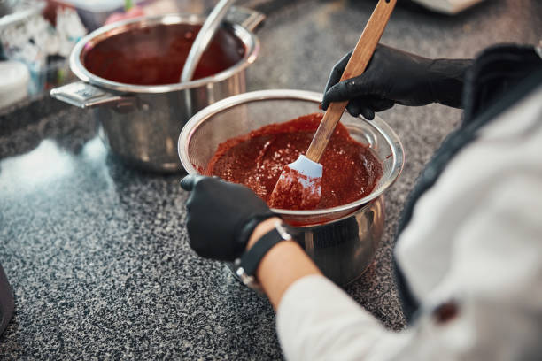 istock Skilled pastry chef preparing sweet filling in the kitchen 1312096429