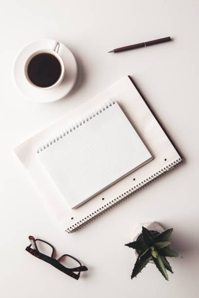 istock Office desk table with supplies, coffee cup and flower. Top view 1312097507