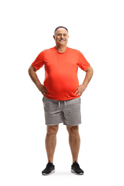Full length portrait of a corpulent mature man smiling and posing Full length portrait of a corpulent mature man smiling and posing isolated on white background chubby arab stock pictures, royalty-free photos & images