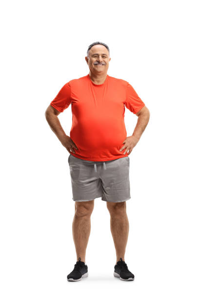 full length portrait of a corpulent mature man smiling and posing - overweight men people abdomen imagens e fotografias de stock