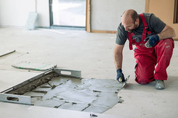 istock Builder preparing and spreading tile adhesive on the floor 1312099034
