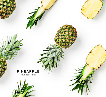 Fresh pineapple fruit with leaves creative layout isolated on white background. Healthy eating and dieting food concept. Tropical fruits composition and design element, flat lay