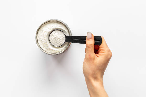 istock Hands holding scoop with whey protein. Sport nutrition 1312099812