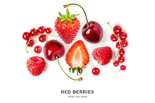 Fresh strawberry, raspberry, cherry, currant berry composition and creative layout on white background. Healthy eating and food concept. Red berries arrangement. Top view, flat lay, design element