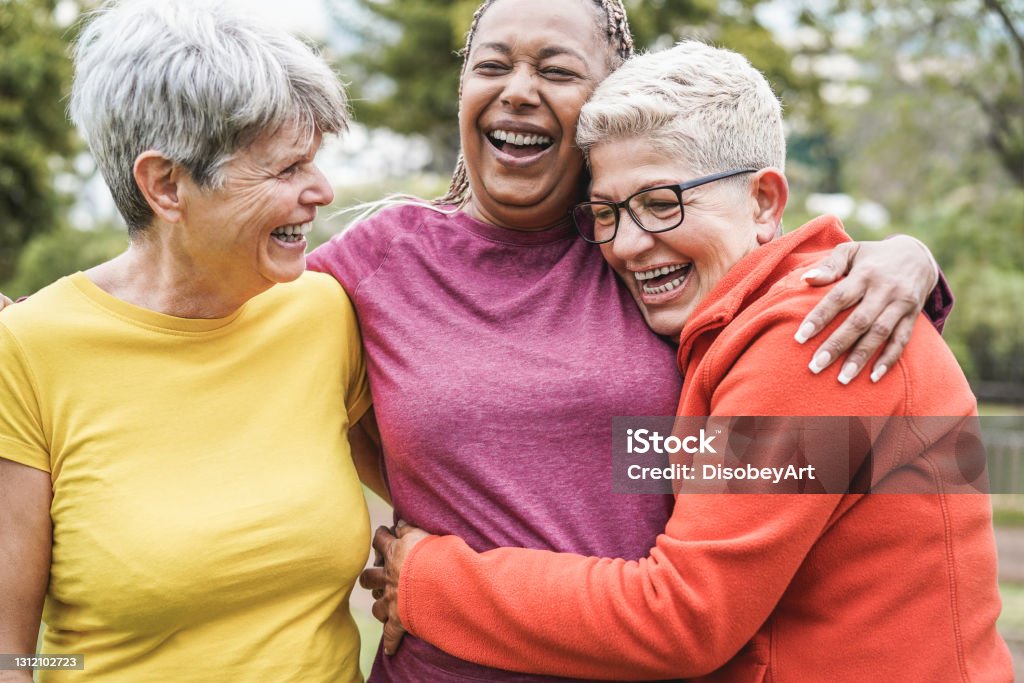 Multiracial senior women having fun together after sport workout outdoor - Main focus on african female face Senior Adult Stock Photo