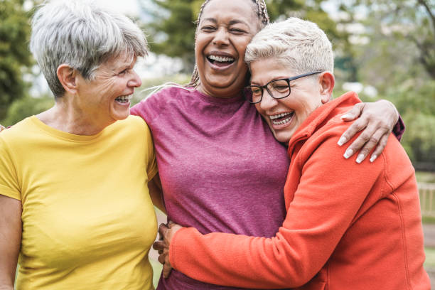 Multiracial senior women having fun together after sport workout outdoor - Main focus on african female face Multiracial senior women having fun together after sport workout outdoor - Main focus on african female face active seniors stock pictures, royalty-free photos & images