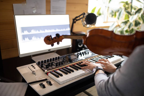 istock Young man composing song in his music studio at home 1312104872