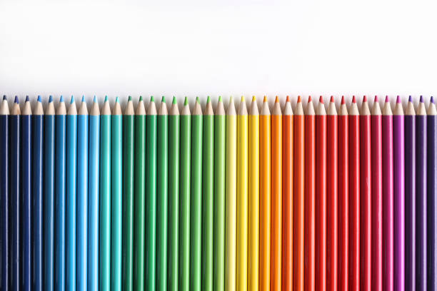 Set of multicolored pencils lying on white background. Children creativity concept