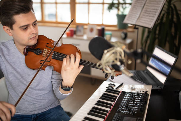 istock Violinist practicing music piece in his music studio at home 1312104935