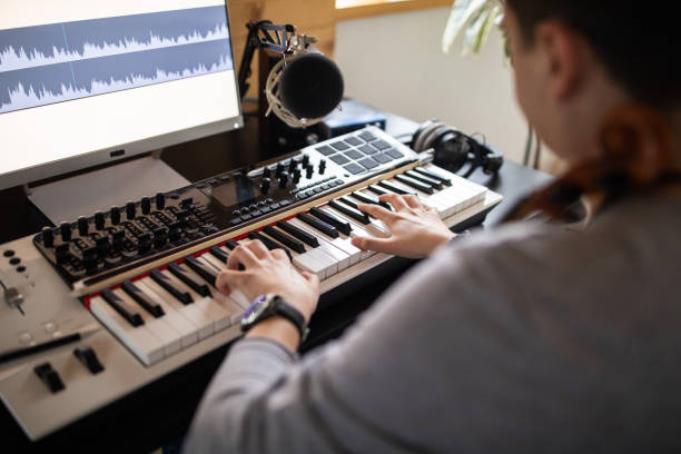 istock Young man composing song in his music studio at home 1312104942