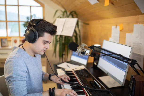 istock Young man composing song in his music studio at home 1312105011