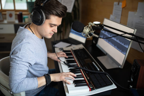 istock Musician composing music on synthesizer in recording studio at home 1312105117