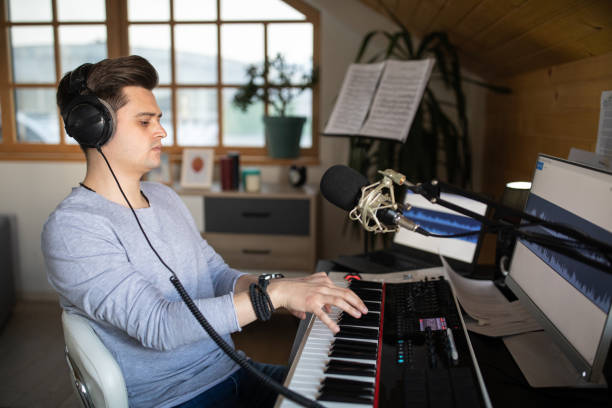 istock Young man composing song in his music studio at home 1312105190