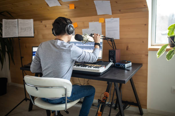 istock Young musician making music in his home recording studio 1312105200