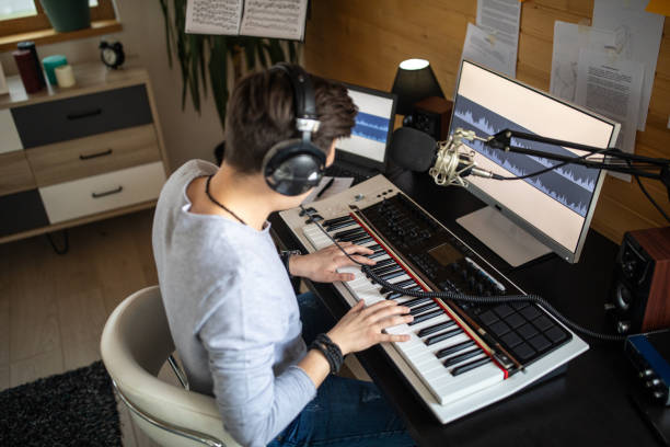 istock Musician composing music on synthesizer in recording studio at home 1312105223
