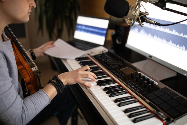 istock Young man composing song in his music studio at home 1312105296