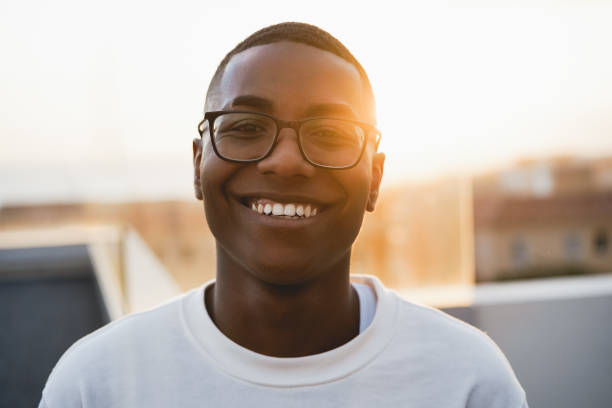istock Happy young african man looking at camera outdoors at summer sunset - Focus on face 1312105489